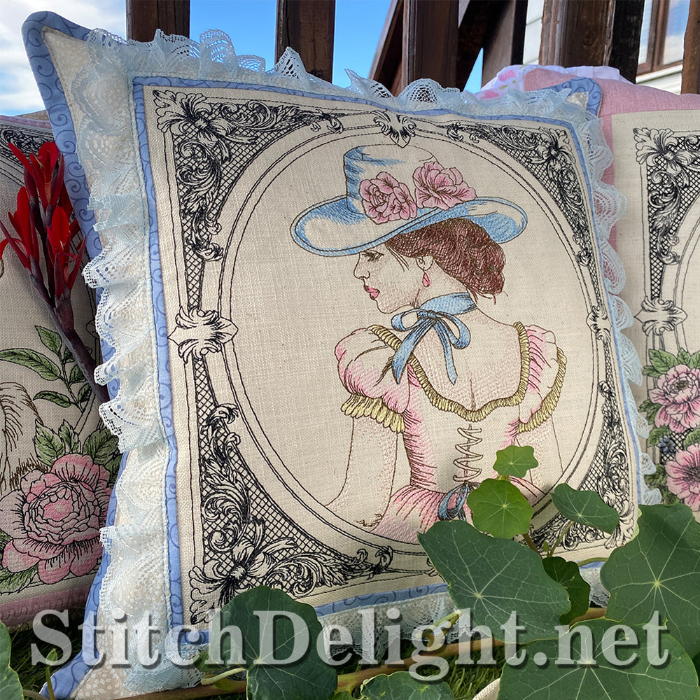 Decorative pillow with an embroidered design of a woman wearing a hat, surrounded by green leaves.