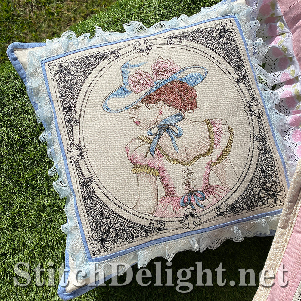 Decorative pillow with embroidered design of a woman in a hat on grass