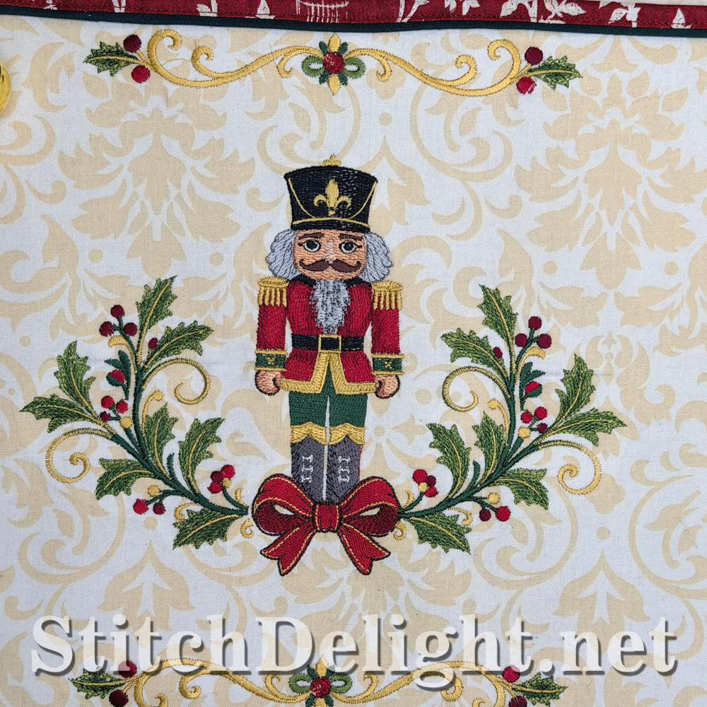 Close-up of the red nutcracker framed by two holly sprays with red berries and a red bow
