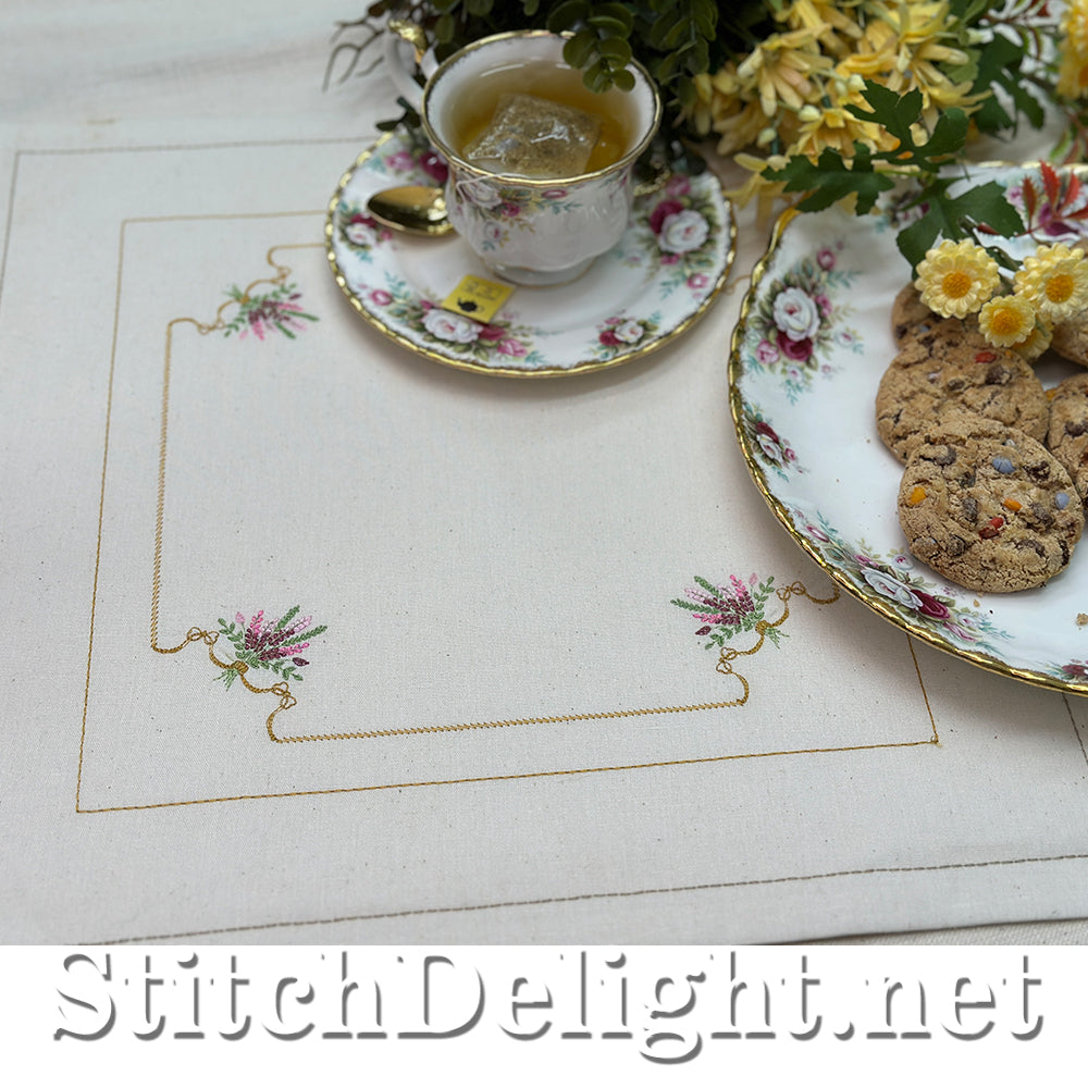 Tea cup with cookies on a decorative table setting with floral elements.