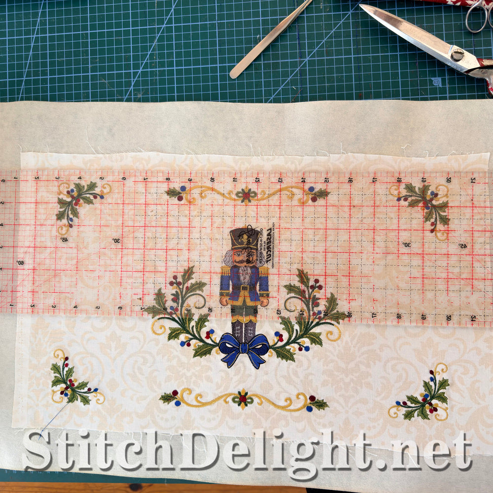 Trimming the finished embroidery to size with a quilting ruler before the binding