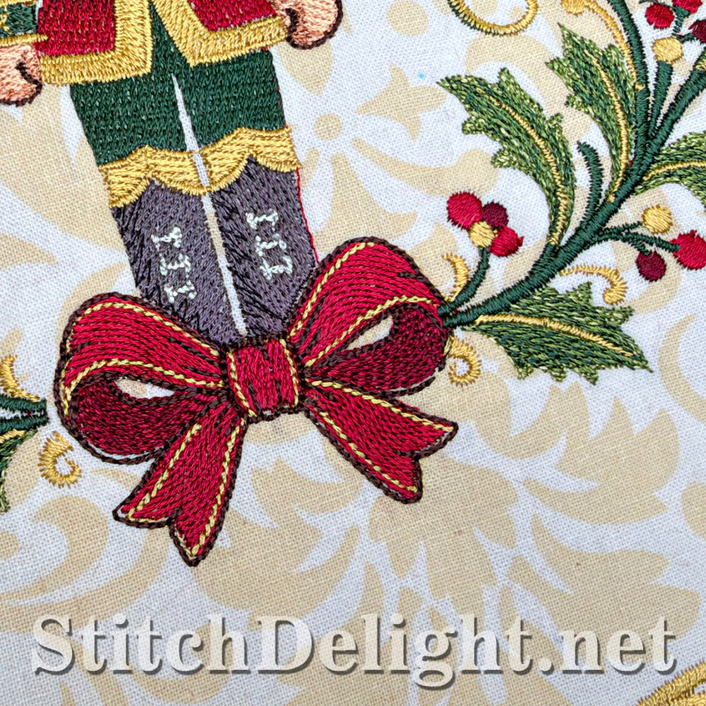 Close-up of the embroidered red bow and holly leaves at the nutcracker's feet