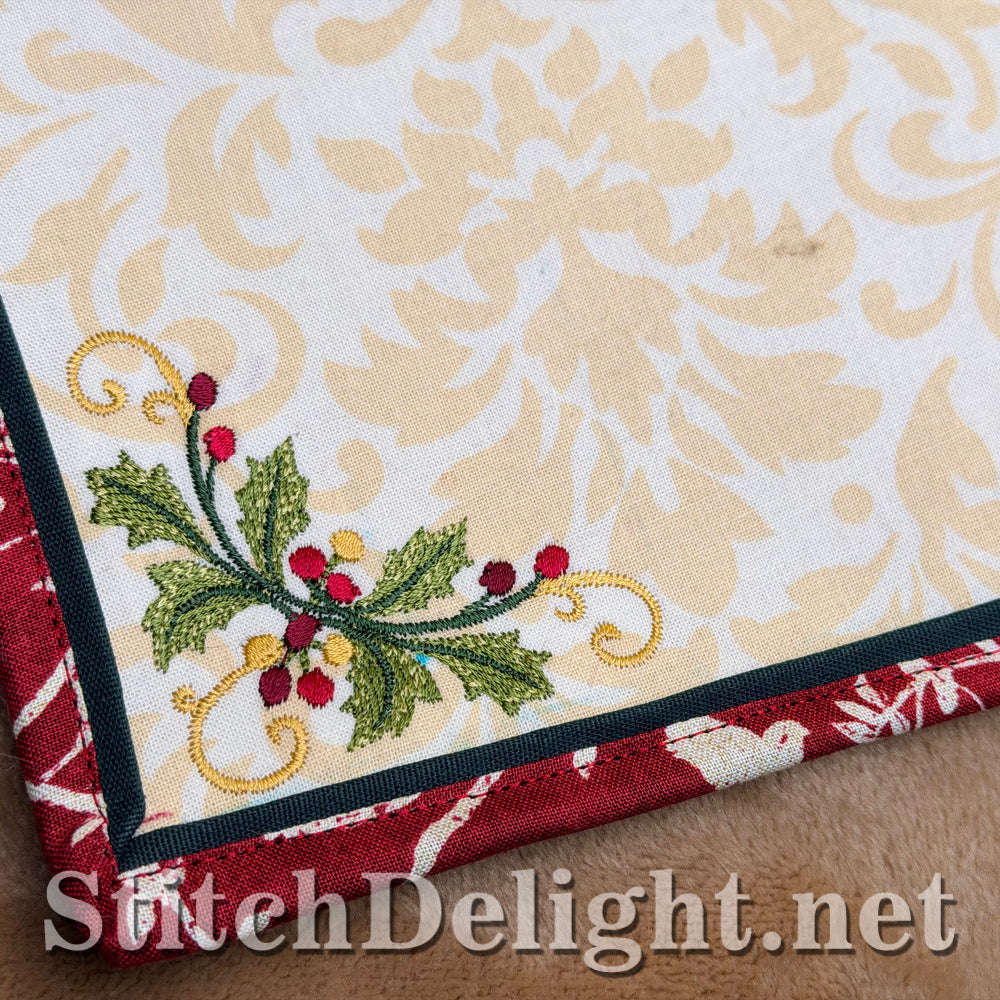 Close-up of a small holly corner next to the red binding and green flange