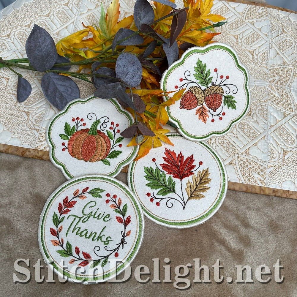 Thanksgiving coasters on a quilted table runner with autumn foliage, ITH embroidery design